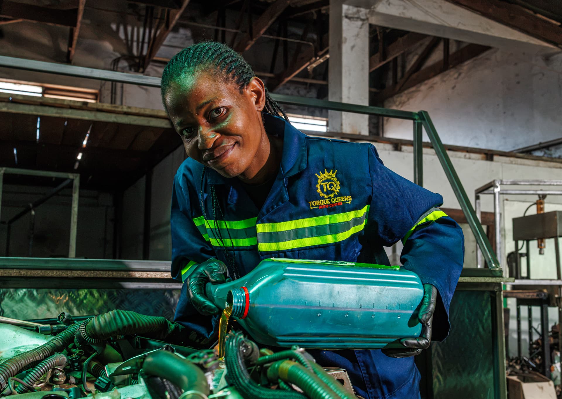 Technician pouring fresh engine oil during a service